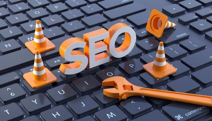 SEO concept with tools and traffic cones on computer keyboard